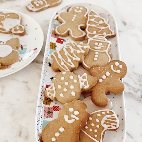 Plate of Christmas gingerbread cookies on white marble bench