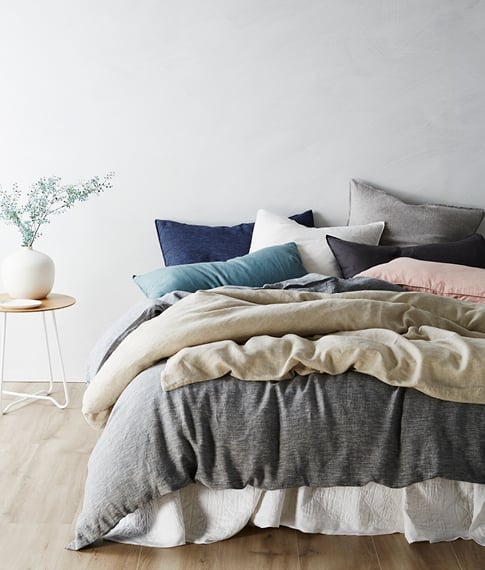vintage washed linen set, various products on the bed such as pillows, sheets, quilt cover and throw