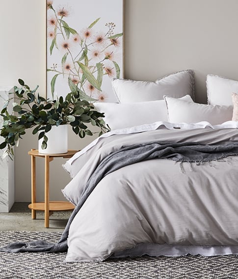 bed with grey bamboo set pillows, sheet and throw