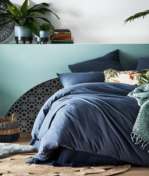 bed with blue ultra soft jersey sheets and matching pillows