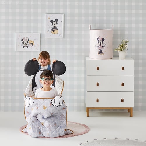 two kids playing in a mickey mouse sleeping bag