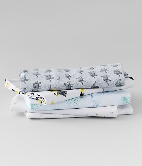 various kids sheets stacked on top of each other in animal print patterns