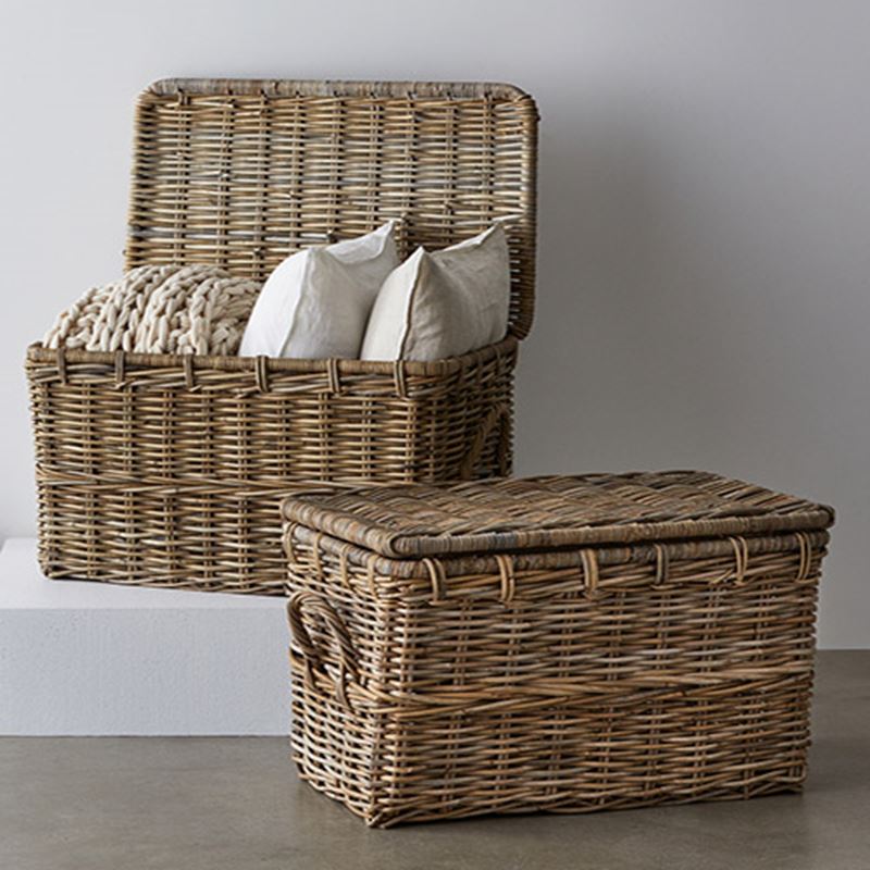 Two straw large storage baskets for the living room, one basket is open with white cushions inside