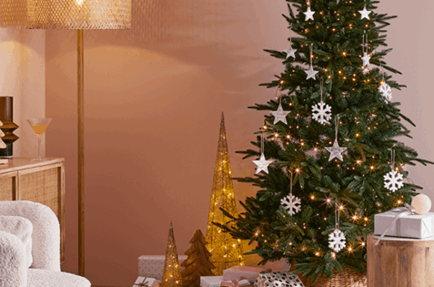 Christmas tree styled with fairy lights and silver decorations.