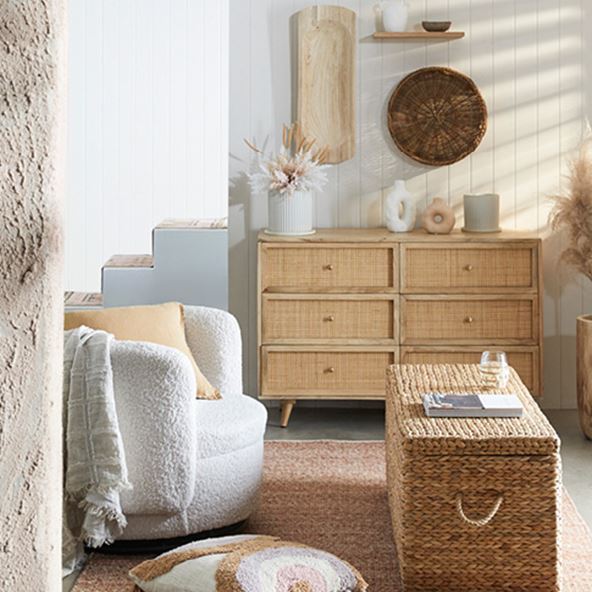 Coastal inspired living room with boucle chair, rattan chest as a coffee table and Anjuna Chests of drawers at the back. 
