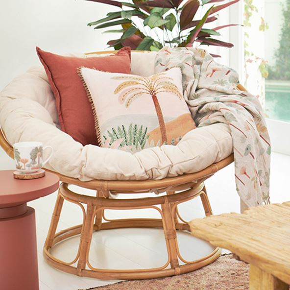 Cayman Rattan Papasan Chair styled with Karina Jambrak cushion, matching throw, and warm hued accessories.