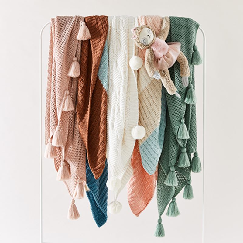 kids throws, various colours displayed on a rack
