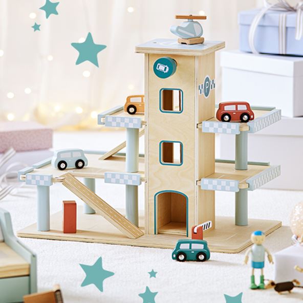 A natural wooden toy carpark with toy cars on each level painted in blue, orange and red with a helicopter on top.  